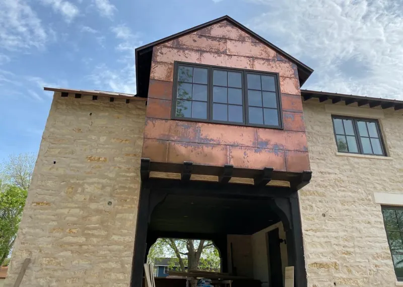 Copper metal panel facade on a stone building for Skylight Installation in Roswell